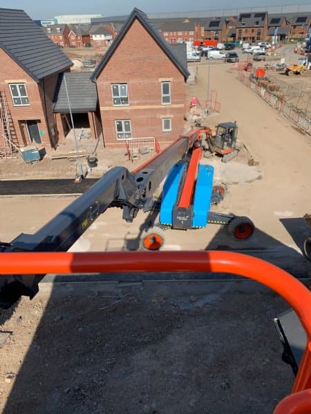 Cherry picker operating on a residential construction site
