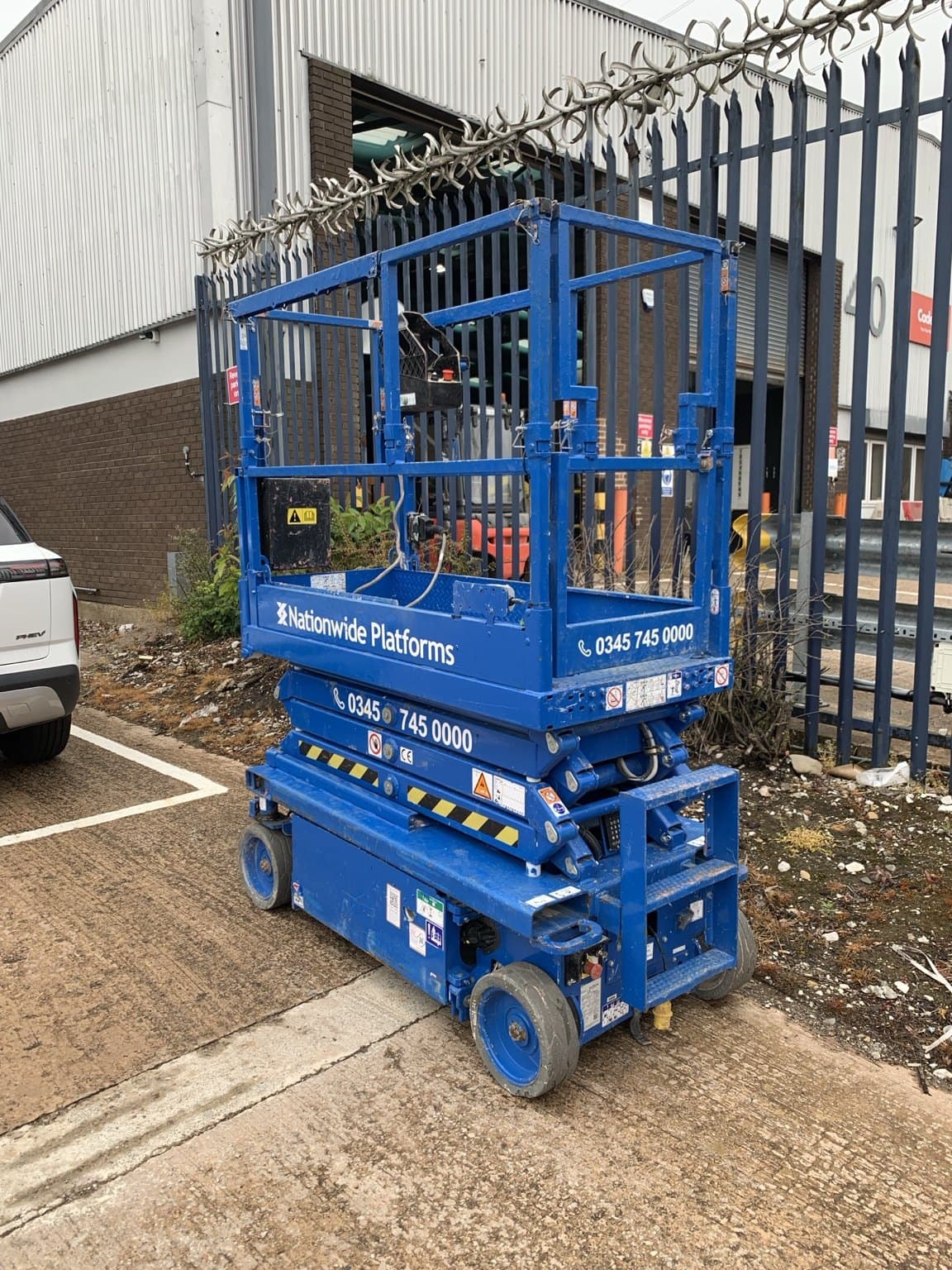 Compact electric scissor lift used for restricted-space access