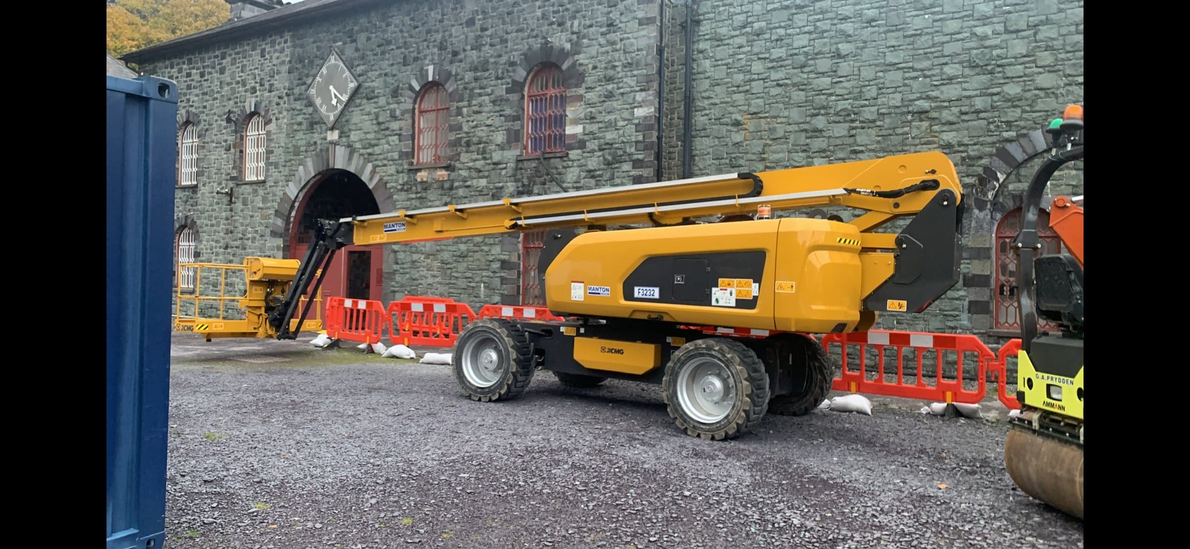 Mobile boom lift operating on an industrial maintenance site