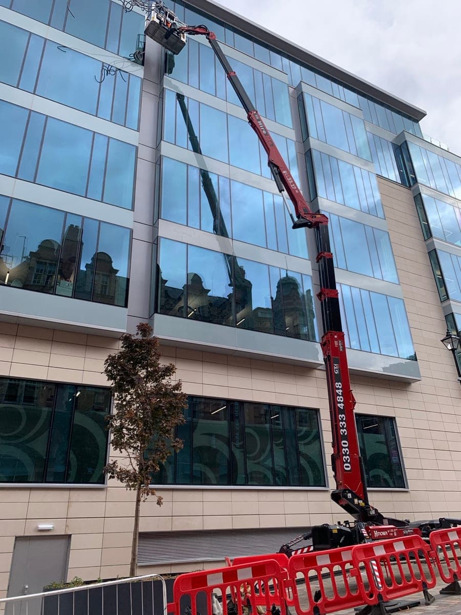 Close view of the spider-lift platform positioned at the glass facade in Birmingham city centre