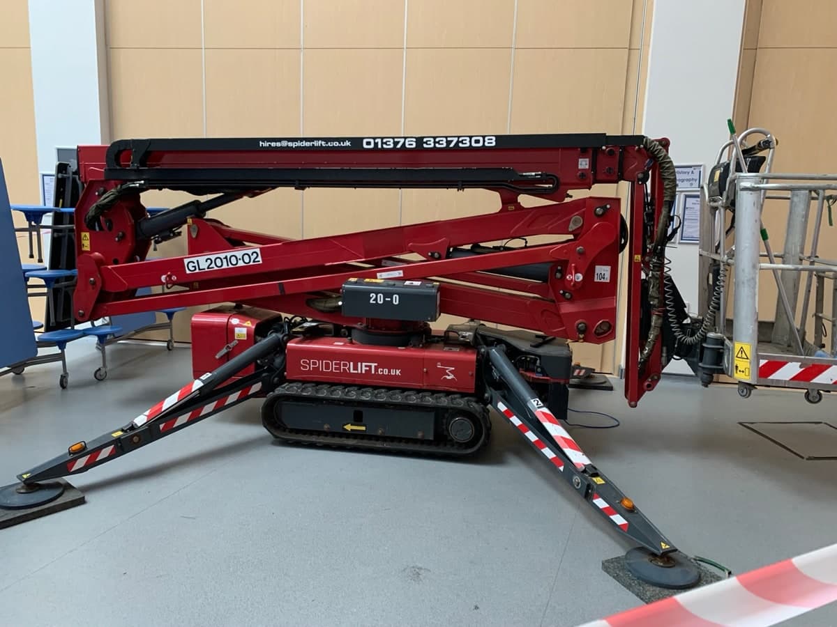 Red spider lift set up on outriggers inside a Bradford building
