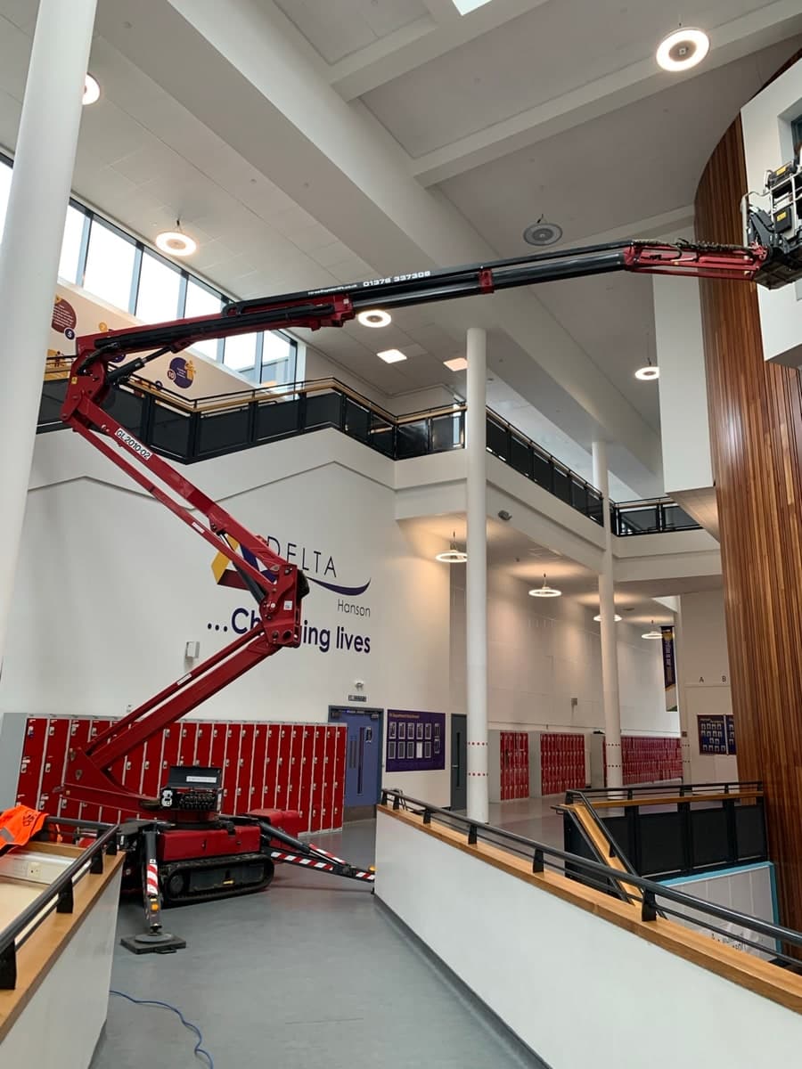 Spider lift boom extended across a large indoor atrium in Bradford