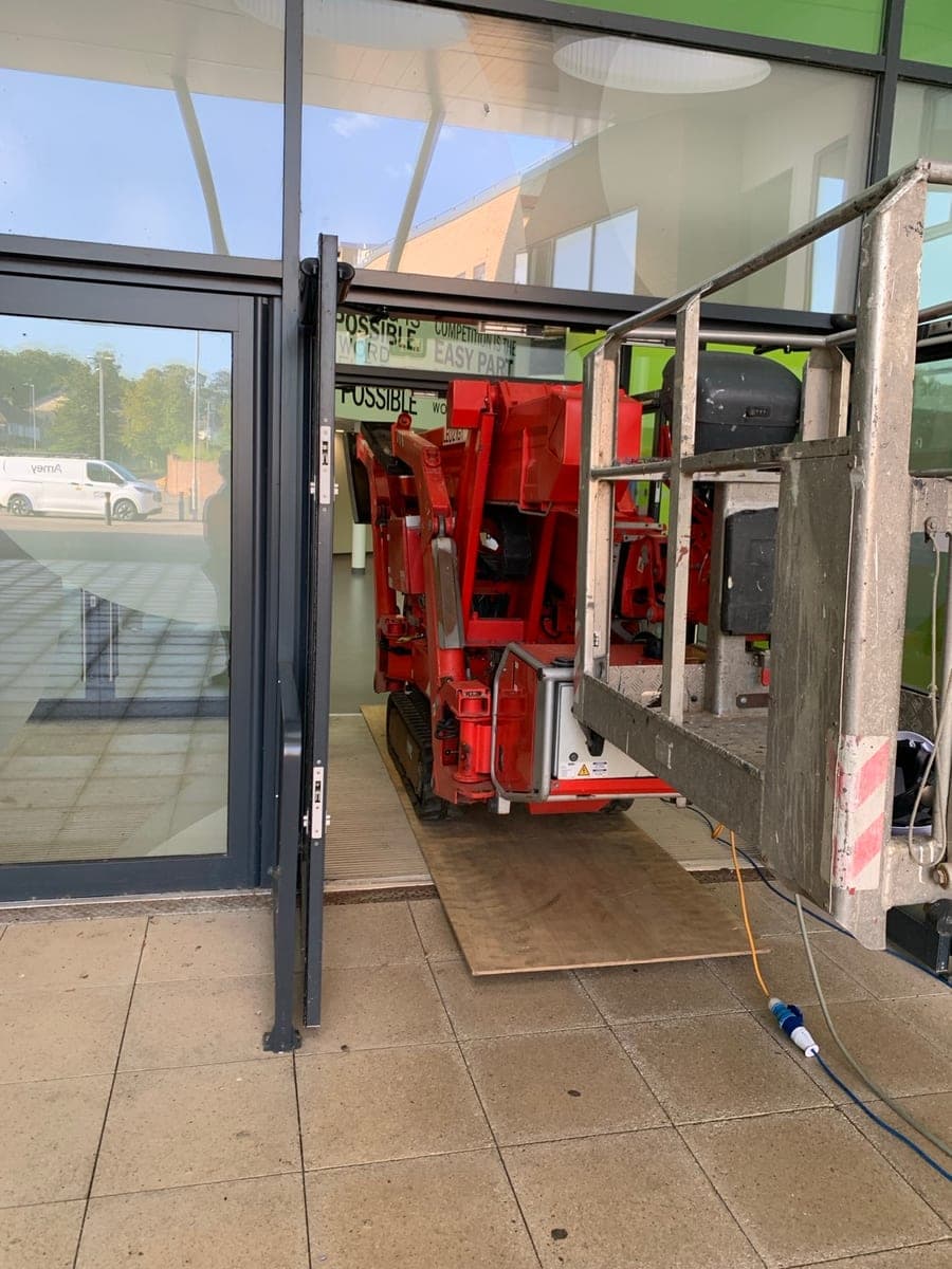 TEUPEN LEO 21 GT spider lift passing through an entrance at an indoor Keighley site