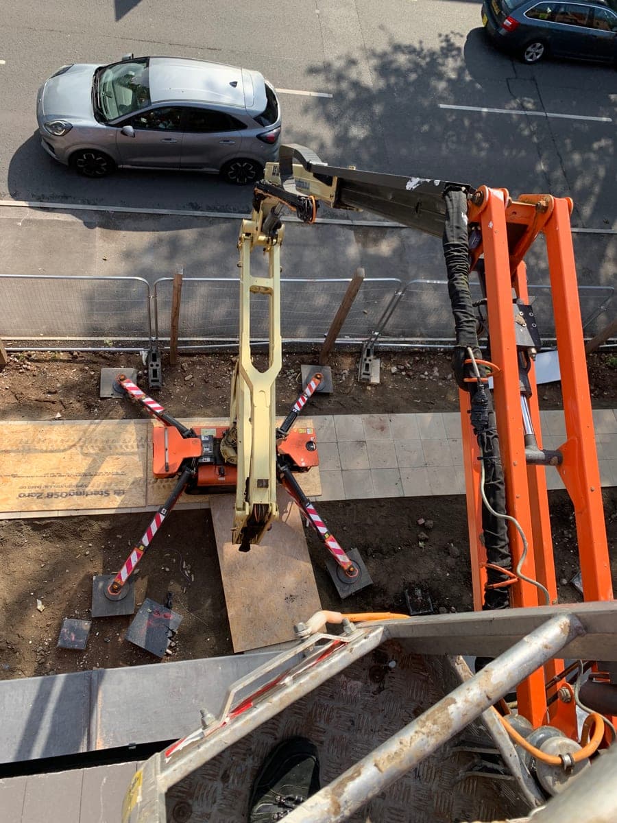 View from the raised platform showing the spider lift and its deployed outriggers