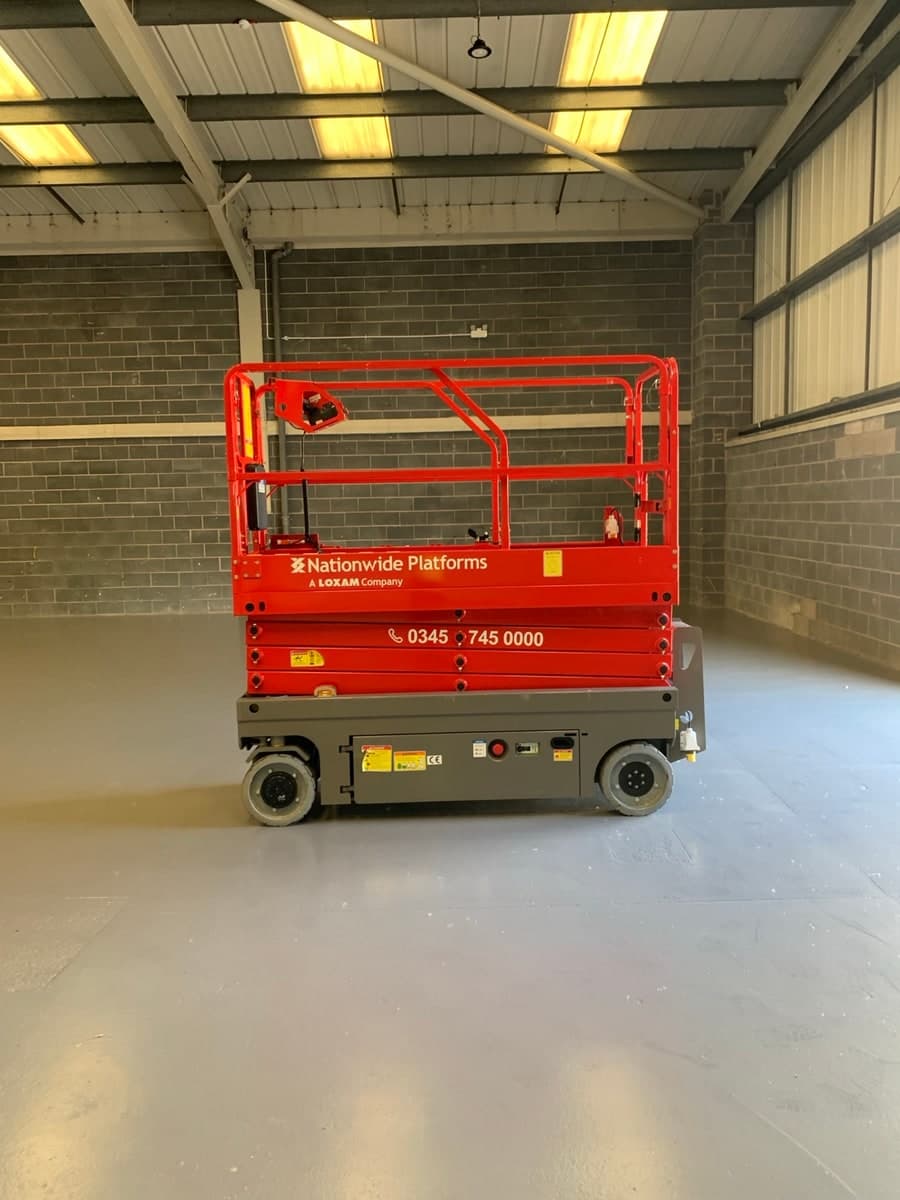 Electric scissor lift inside an industrial unit in Warrington
