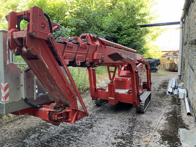 Oil and Steel Octoplus tracked spider lift in folded transport position showing compact tracked undercarriage